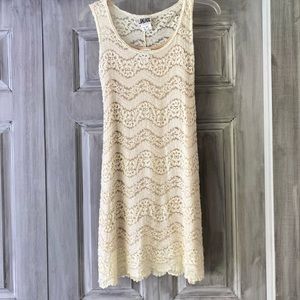 Ivory lace sleeveless dress.